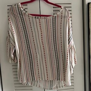 Large hangaround shirt.white background with stripes going down the shirt.